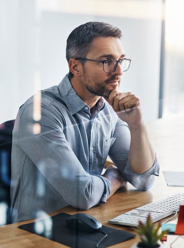 Cropped Shot Of A Businessman Working On His Computer At His Desk