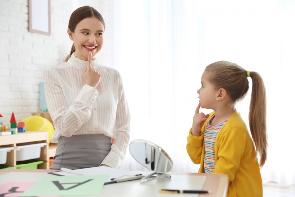 Speech therapist helping child